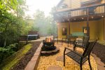 Backyard with hot tub, fire pit, and custom 52 Retreat mural